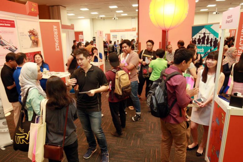 People attending a SkillsFuture Earn and Learn Carnival in Singapore. More than 120,000 people have taken courses, at the end of the initiative's first year. But more needs to be done across Southeast Asia. PHOTO: SPH FILE